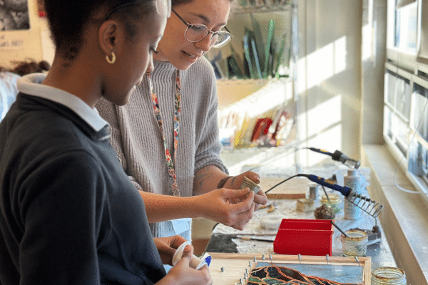 art teacher helping student in classroom