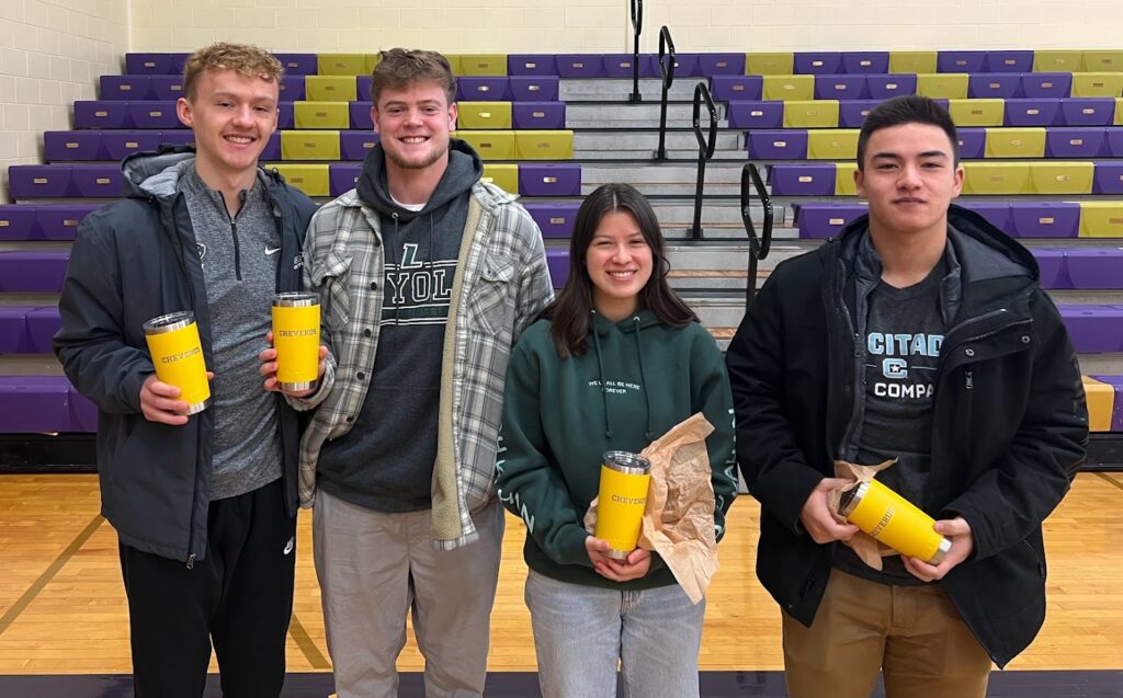 group of young alumni holding cups