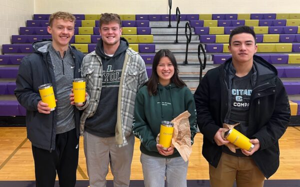 group of young alumni holding cups