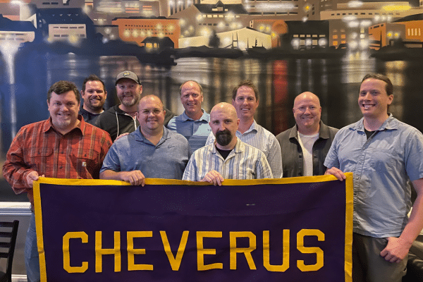 group of alumni with school banner